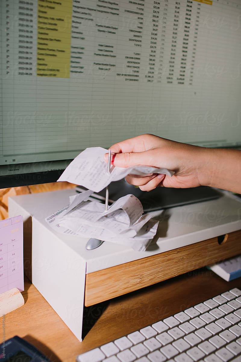 Person entering receipts into a digital spreadsheet